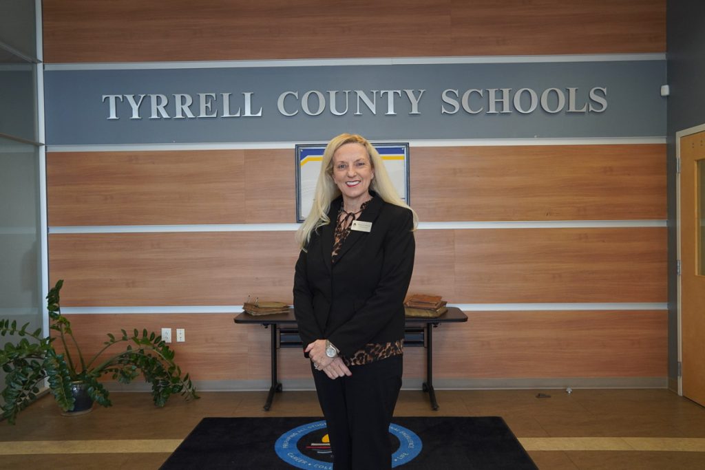 Woman standing in front of Tyrrell County Schools sign