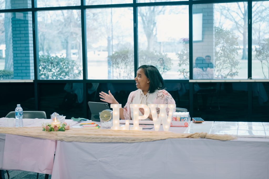 Dr. Kimberly Bryant leads a student session sitting at table.
