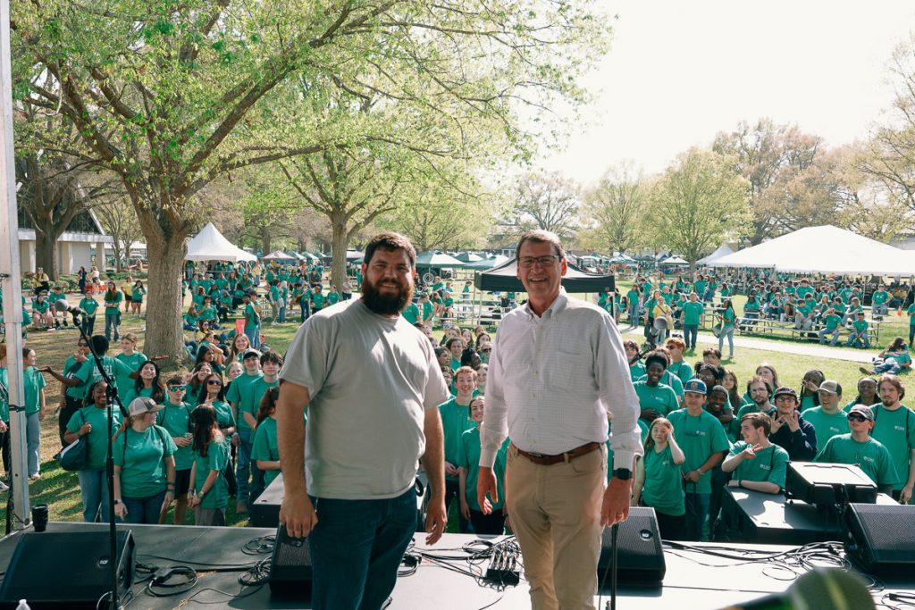 UMO President and UMO AG Center Director stand on stage in front of students at AG Fest.