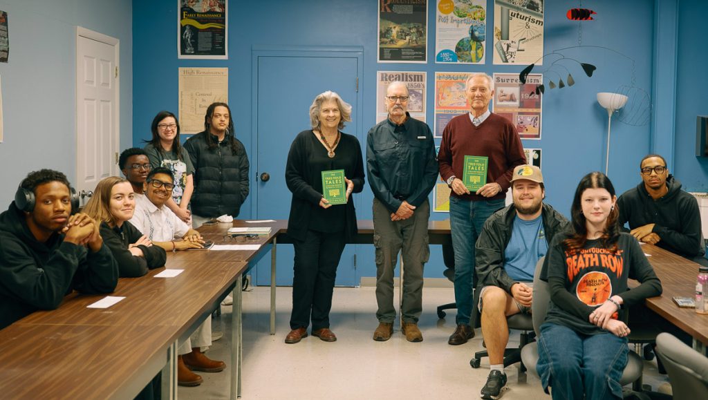 Group of students, current and former professors, in literature classroom